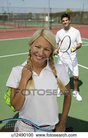 Female tennis player standing on tennis court, portrait View Large Photo Image Stock Image - Female tennis player standing on tennis court, portrait. Fotosearch