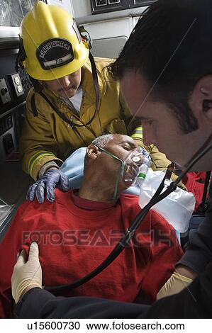 Firefighter and paramedic helping man in ambulance View Large Photo Image Stock Image - Firefighter and paramedic helping man in ambulance. Fotosearch