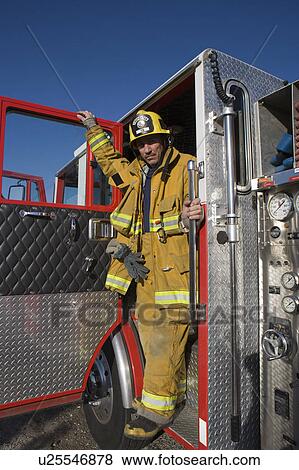 Stock Photo - Firefighter in truck. Fotosearch