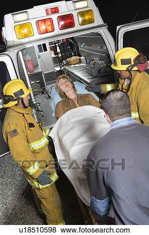 Firefighters and paramedic lifting woman into ambulance View Large Photo Image Stock Photo - Firefighters and paramedic lifting woman into ambulance. Fotosearch