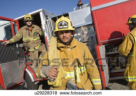Firefighters and truck View Large Photo Image Stock Photo - Firefighters and truck. Fotosearch