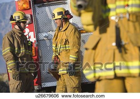 Stock Photograph - Firefighters and vehicle. Fotosearch