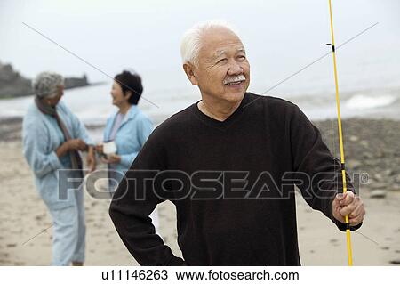 Stock Image - Fisherman on beach. Fotosearch