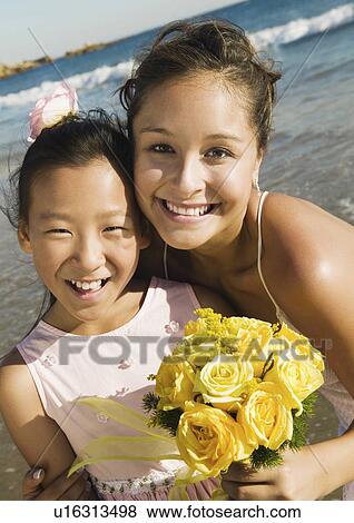 Flower girl and Bride at ocean, (portrait) View Large Photo Image Stock Photo - Flower girl and Bride at ocean, (portrait). Fotosearch