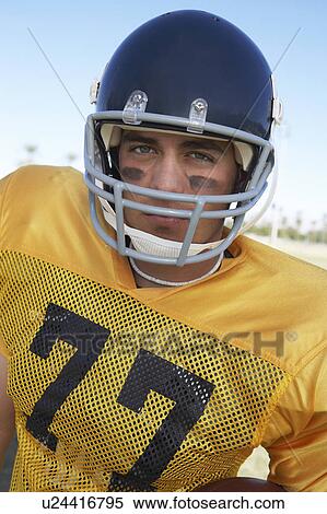 Stock Photography - Football Player in helmet on field, portrait, (portrait). Fotosearch