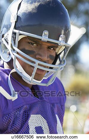 Football Player wearing helmet on field, portrait, (portrait) View Large Photo Image Stock Photograph - Football Player wearing helmet on field, portrait, (portrait). Fotosearch