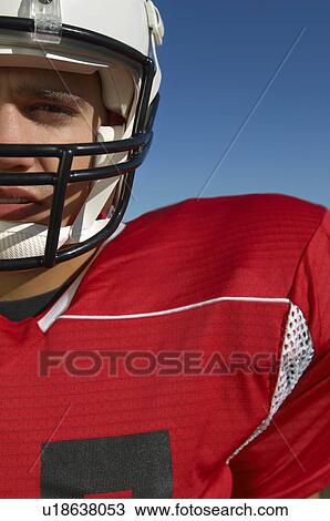 Stock Image - Football Player wearing helmet, close-up, portrait, cropped, (close-up), (portrait). Fotosearch