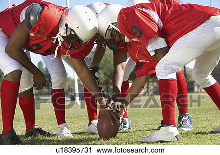 Football Players in Huddle around ball View Large Photo Image Stock Image - Football Players in Huddle around ball. Fotosearch