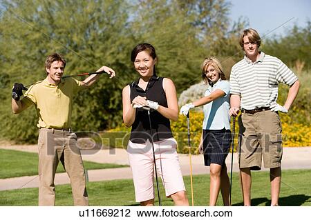 Four golfers standing on golf course View Large Photo Image Stock Image - Four golfers standing on golf course. Fotosearch