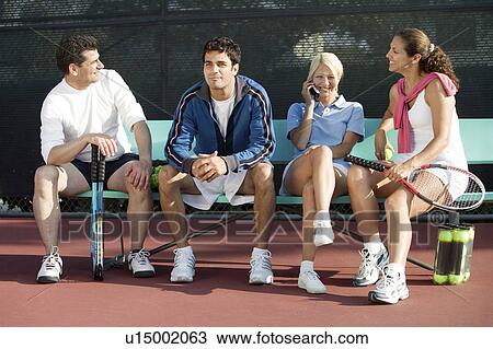 Four mixed doubles tennis players sitting at tennis court, front view View Large Photo Image Stock Image - Four mixed doubles tennis players sitting at tennis court, front view. Fotosearch
