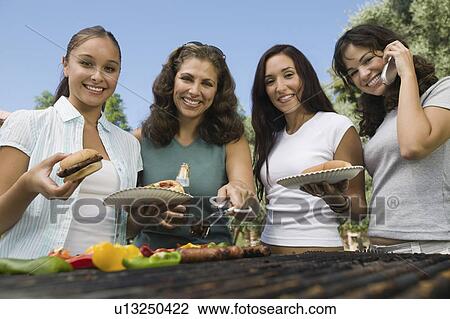 Four women around outdoor picnic, portrait View Large Photo Image Stock Image - Four women around outdoor picnic, portrait. Fotosearch