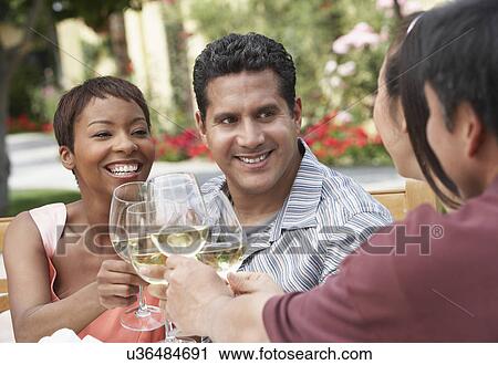 Friends drinking wine outdoors, head and shoulders View Large Photo Image Stock Image - Friends drinking wine outdoors, head and shoulders. Fotosearch