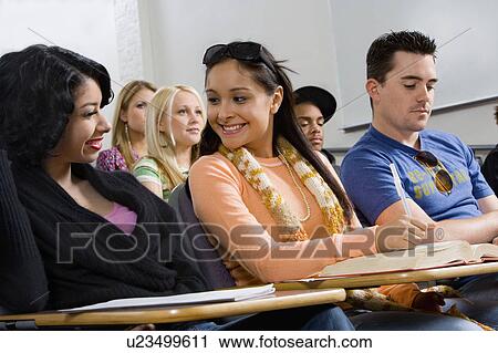 Stock Image - Friends sitting in class lecture. Fotosearch