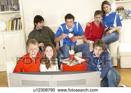 Stock Image - Friends watching sport on TV. Fotosearch