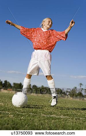 Girl (13-17) jumping whilst playing soccer View Large Photo Image Stock Image - Girl (13-17) jumping whilst playing soccer. Fotosearch