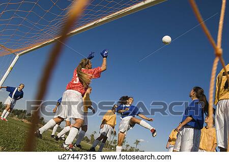 Stock Photography - Girl (13-17) waiting to score with soccer ball. Fotosearch