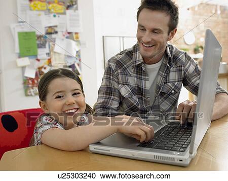 Girl (3-6) using laptop with father at home View Large Photo Image Stock Image - Girl (3-6) using laptop with father at home. Fotosearch