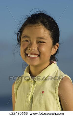 Stock Photograph - Girl (7-9) smiling, (close-up), (portrait). Fotosearch