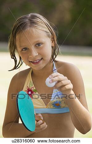 Girl (7-9) wearing bikini holding table tennis paddle and ball, portrait. View Large Photo Image Stock Image - Girl (7-9) wearing bikini holding table tennis paddle and ball, portrait.. Fotosearch