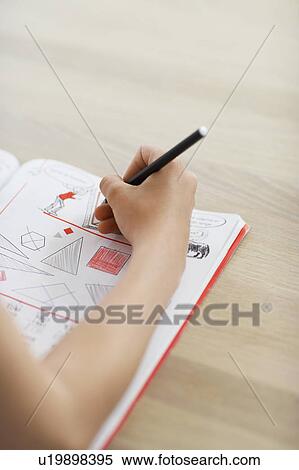 Girl doing geometry homework on table, close up of hand View Large Photo Image Stock Photography - Girl doing geometry homework on table, close up of hand. Fotosearch