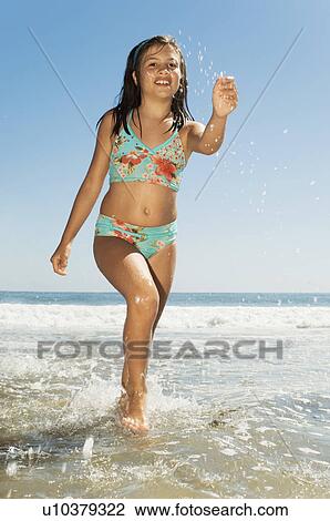Girl in swimwear running in sea View Large Photo Image Stock Image - Girl in swimwear running in sea. Fotosearch