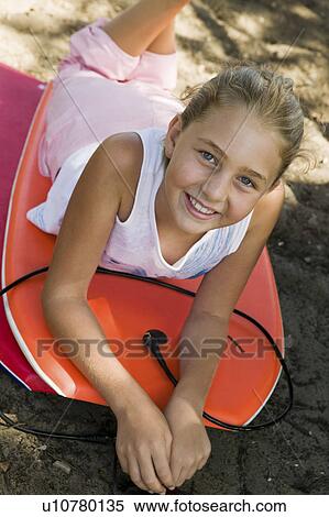 Stock Photography - Girl Lying on Boogie Boards. Fotosearch