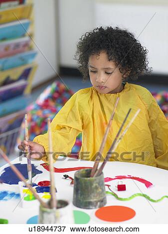 Girl painting in art class, elevated view View Large Photo Image Stock Photo - Girl painting in art class, elevated view. Fotosearch