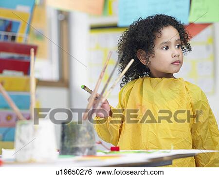 Girl painting in art class View Large Photo Image Stock Photograph - Girl painting in art class. Fotosearch