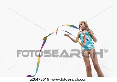 Girl playing with stick streamer, low angle view View Large Photo Image Stock Photo - Girl playing with stick streamer, low angle view. Fotosearch