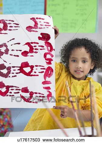 Girl presenting her finger painting in art class View Large Photo Image Stock Image - Girl presenting her finger painting in art class. Fotosearch