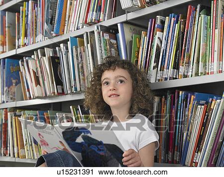 Girl reading book in library View Large Photo Image Stock Image - Girl reading book in library. Fotosearch