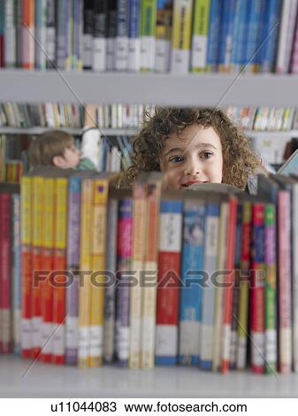 Girl selecting books from library bookshelf View Large Photo Image Stock Image - Girl selecting books from library bookshelf. Fotosearch