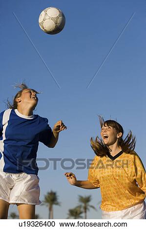 Girls (13-17) attempting to head soccer ball View Large Photo Image Stock Image - Girls (13-17) attempting to head soccer ball. Fotosearch