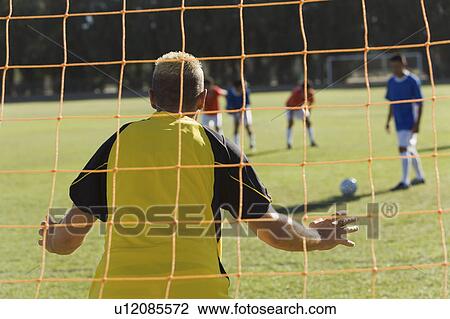Goalkeeper defending, back view View Large Photo Image Stock Image - Goalkeeper defending, back view. Fotosearch