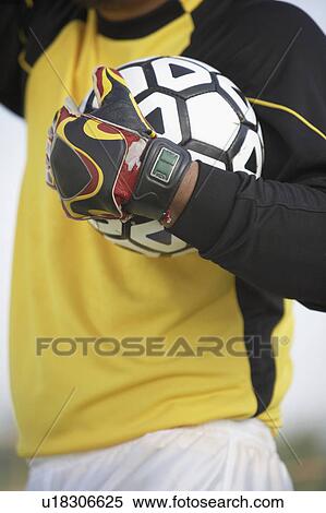 Goalkeeper holding ball, mid section View Large Photo Image Stock Photography - Goalkeeper holding ball, mid section. Fotosearch