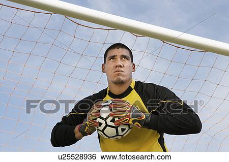 Goalkeeper holding ball, portrait View Large Photo Image Stock Photograph - Goalkeeper holding ball, portrait. Fotosearch