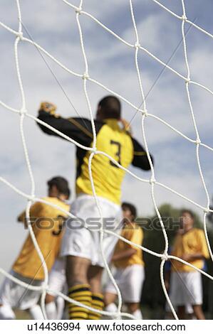 Goalkeeper jumping for soccer ball, back view View Large Photo Image Picture - Goalkeeper jumping for soccer ball, back view. Fotosearch