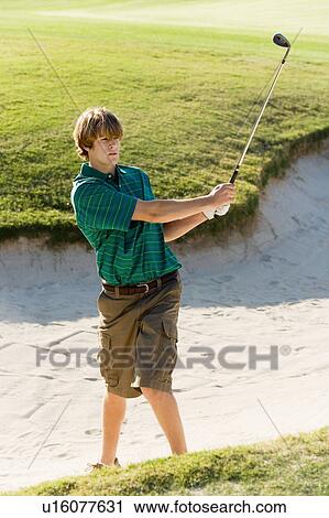 Golfer hitting ball from sand trap View Large Photo Image Stock Image - Golfer hitting ball from sand trap. Fotosearch