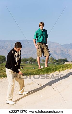 Golfer hitting ball from sand trap View Large Photo Image Stock Image - Golfer hitting ball from sand trap. Fotosearch