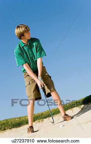 Golfer hitting ball from sand trap View Large Photo Image Stock Image - Golfer hitting ball from sand trap. Fotosearch