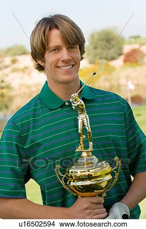 Golfer holding trophy View Large Photo Image Picture - Golfer holding trophy. Fotosearch
