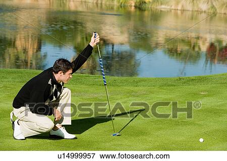 Golfer lining up putt View Large Photo Image Stock Photo - Golfer lining up putt. Fotosearch