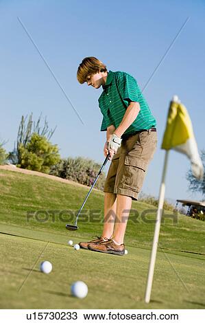 Golfer putting on golf course View Large Photo Image Stock Image - Golfer putting on golf course. Fotosearch