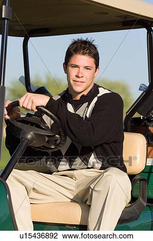 Golfer riding in golf cart, (portrait) View Large Photo Image Stock Image - Golfer riding in golf cart, (portrait). Fotosearch