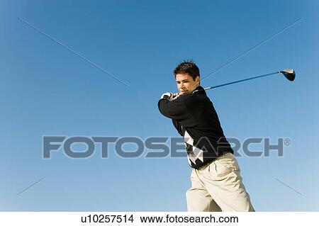 Golfer swinging club View Large Photo Image Picture - Golfer swinging club. Fotosearch