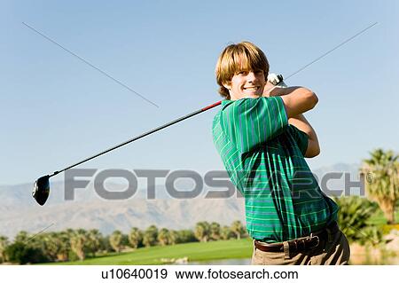 Golfer swinging club View Large Photo Image Stock Photo - Golfer swinging club. Fotosearch