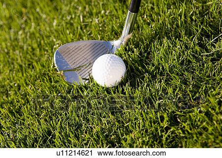 Stock Image - Golfer teeing off, close up on ball. Fotosearch
