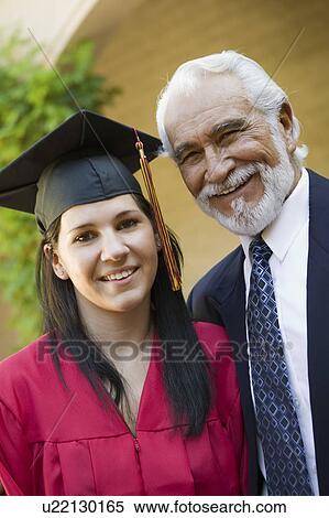 Stock Photography - Graduate and grandfather outside, portrait. Fotosearch