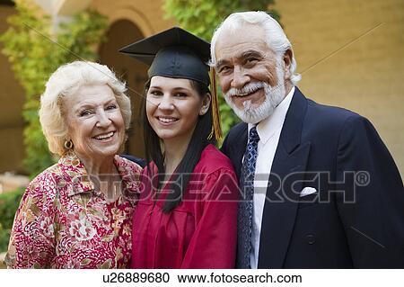 Stock Image - Graduate and grandparents outside, portrait. Fotosearch