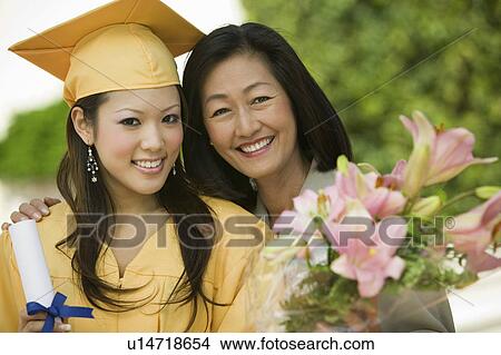 Graduate and mother outside, portrait View Large Photo Image Picture - Graduate and mother outside, portrait. Fotosearch